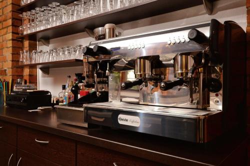 a bar with a coffee maker on a counter at Hotel am Stadtwald in Stralsund