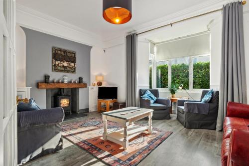 a living room with a couch and a table at Sunbury Villa - Close to Town and Beaches in Tenby