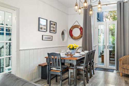 a dining room with a table and chairs at Sunbury Villa - Close to Town and Beaches in Tenby