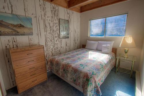 a bedroom with a bed and a dresser and a lamp at Life's Better The Milky Way condo in Stateline