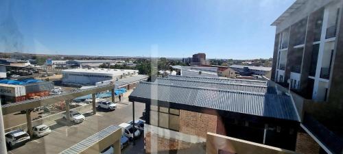 a view of a city with cars parked in a parking lot at DEE-LOFT 53 in Windhoek