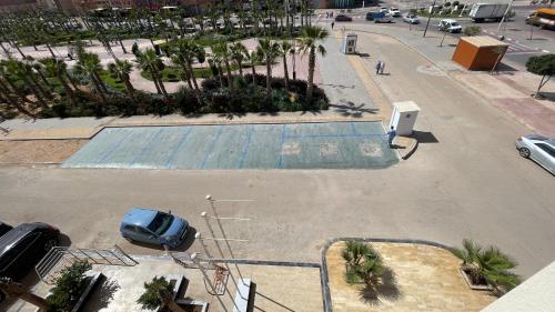 an empty parking lot with a car parked in it at Residence Achomoukhe in Laayoune