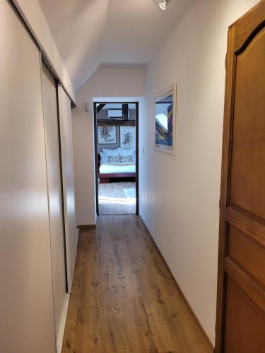 a hallway leading to a room with a bed at La Merlette89 in Lailly