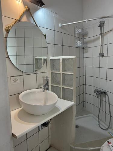 a white bathroom with a sink and a shower at Maravillosas vistas al mar "Primera Línea" Apartamentos Can Toca - Seahouses in Santa Cruz de Tenerife