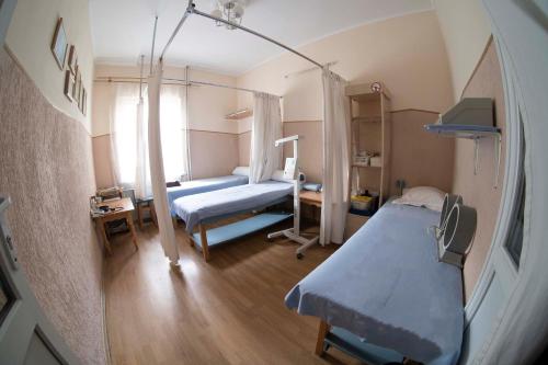 a hospital room with two beds and a window at SPA Villa Jasmin in Truskavets