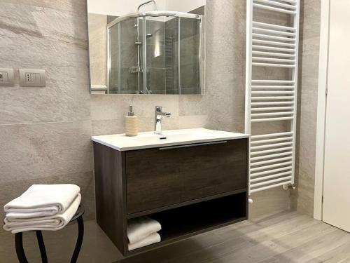een badkamer met een wastafel en een spiegel bij Casa Patrito - Appartamento Dolcetto in Barolo