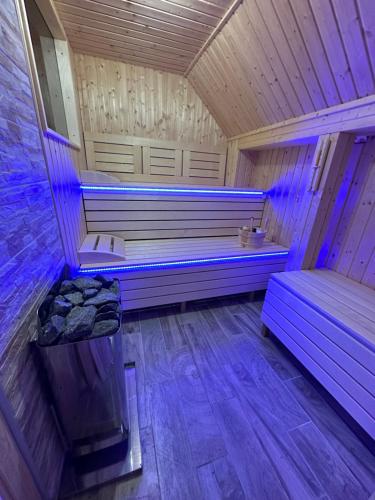 sauna z fioletowymi światłami w drewnianej kabinie w obiekcie Farkas Guesthouse w mieście Balatonszentgyörgy