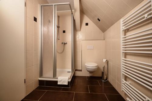a bathroom with a shower and a toilet at Hotel am Stadtwald in Stralsund
