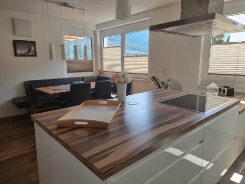 a kitchen with a wooden counter top and a table at Ferienlandhaus Höfer in Fulpmes
