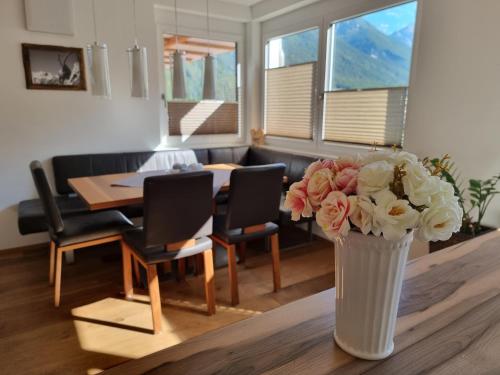 a vase of flowers on a table in a living room at Ferienlandhaus Höfer in Fulpmes
