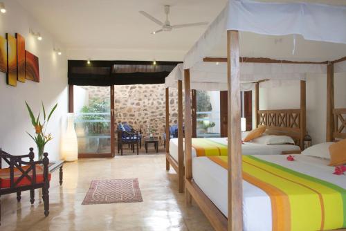 a bedroom with two bunk beds and a living room at Ratnakara in Dondra East