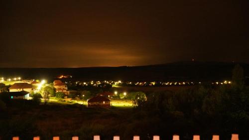 a view of a town at night with lights at Őzgida vendégház in Egerszalók