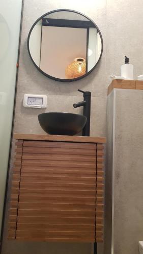 a bathroom with a black sink and a mirror at Sun, Mountain & Adventure in Arad