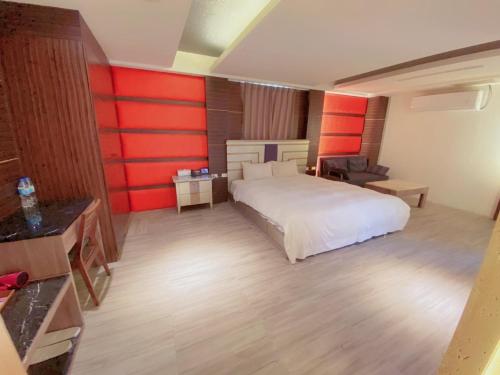 a bedroom with a white bed and red walls at Michelle hotel in Yuanlin