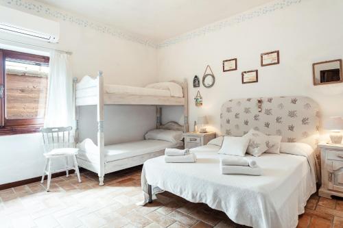 a bedroom with two bunk beds and a chair at Villa Regina Margherita in Olbia