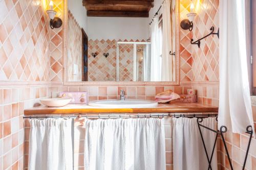 a bathroom with a sink and a mirror at Villa Regina Margherita in Olbia