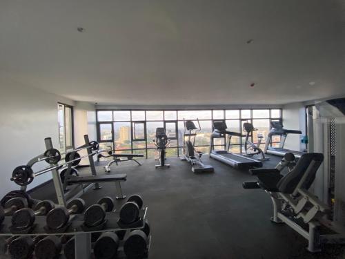 a gym with several treadmills and cardio machines at PARANAIS APARTMENT 2 in Nairobi