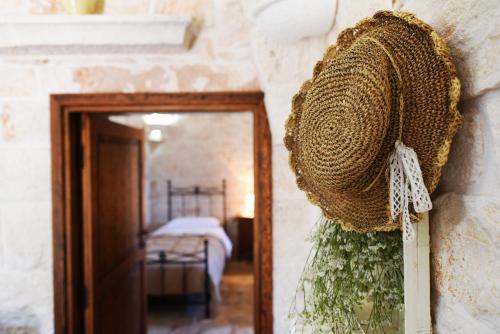 a wreath hanging on a wall next to a mirror at Masseria Peppeturro in Cisternino