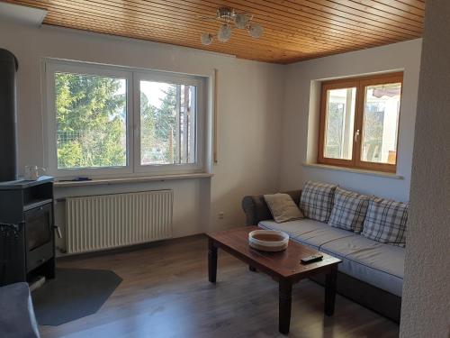 a living room with a couch and a table at Hochgratstrasse in Oberreute