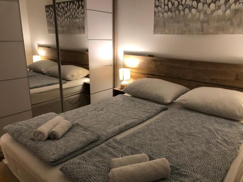 a bedroom with a bed with two towels on it at Apartment Aura in Belgrade