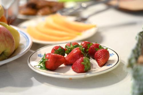 a plate of strawberries sitting on a table at Masseria Peppeturro in Cisternino