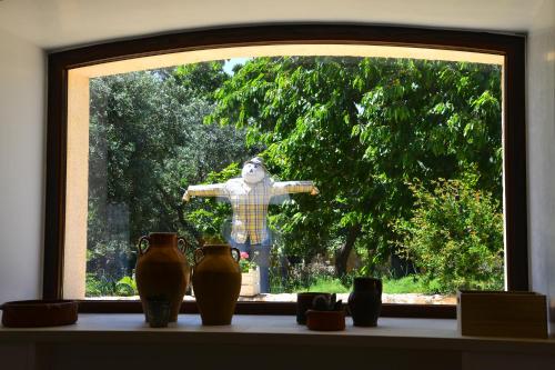 a window with a teddy bear looking out of it at Masseria Peppeturro in Cisternino
