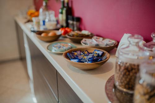 a buffet with bowls of food on a counter at Hotel Maj Inn in Moravske Toplice