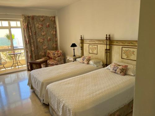 2 camas en una habitación de hotel con balcón en Apartamento Puerto Sotogrande Marina, en Sotogrande