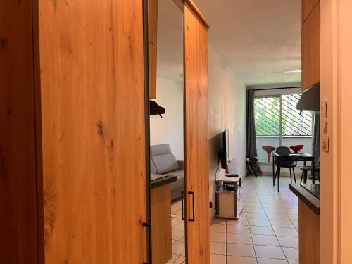a room with a door leading to a living room at Le ti Canbou - Studio - Près de la plage -By Sister Home in Saint-Gilles les Bains