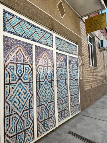 a pair of doors with mosaics on the side of a building at AL-MOTRUDIY in Samarkand