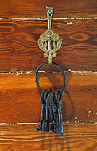 a bunch of keys hanging on a wooden door at Seascape Tropical Inn in Key West