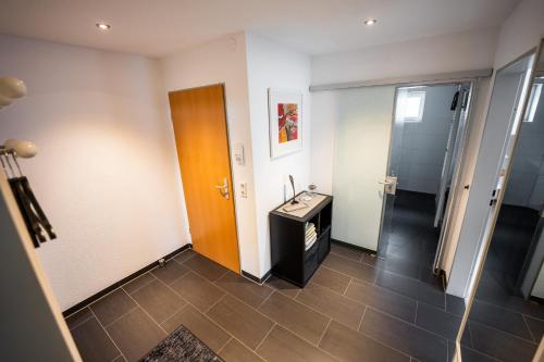 a room with a bathroom with a sink and a door at Ländliche 2-Zimmer Wohnung in Bad Ditzenbach