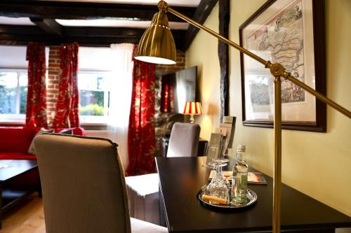 a dining room with a table and a lamp at Gut Basthorst in Basthorst