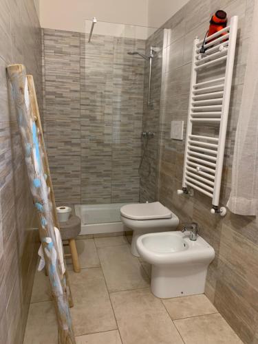 a bathroom with a toilet and a sink and a shower at Villa Anna GuestHouse in Brindisi