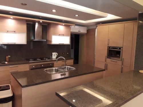 a kitchen with a sink and a counter top at Luxury Apartment In Massaken Sheraton near Cairo Int'l Airport in Cairo