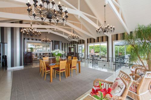 a dining room with a table and chairs at On The Point - Lake Rotorua in Rotorua