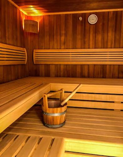 a inside of a sauna with a bucket on the floor at Heimelige Ferienwohnung mit Sicht in die Bergwelt in Bivio