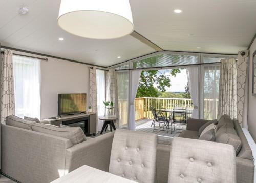 a living room with a couch and a television at Blaithwaite Country House Estate in Wigton