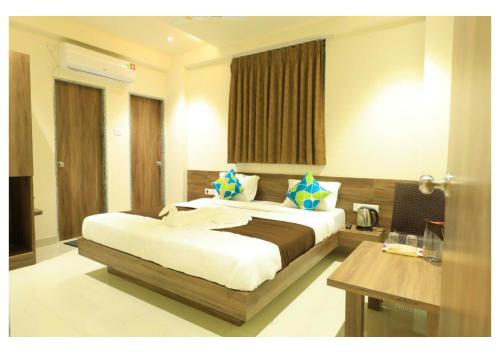 a bedroom with a large bed in a room at Hotel Scintilla in Somnath