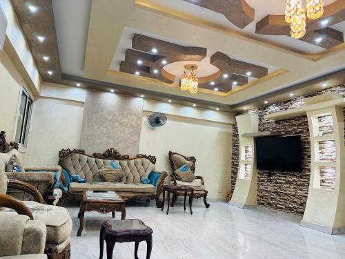 a living room with couches and a flat screen tv at 91 الميرلاند الدور 7 in Cairo
