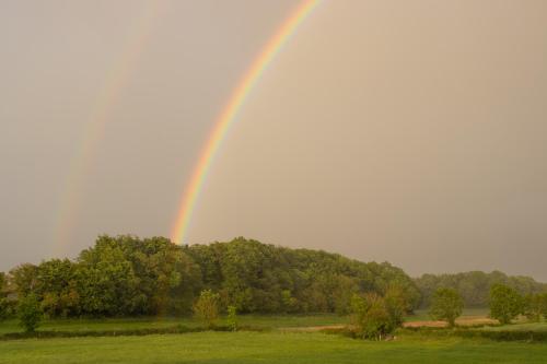 a rainbow in the sky over a field at Woodview Lodge in Trim