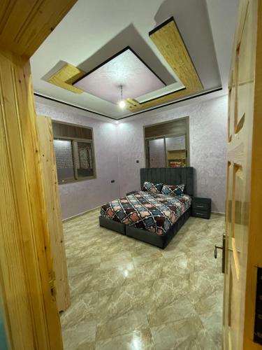 a bedroom with a bed in the middle of a room at House tour dakhla in Dakhla