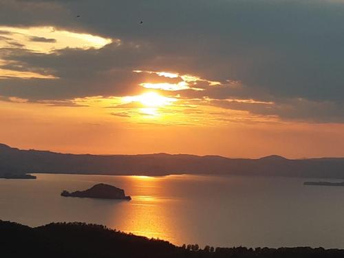 a sunset over a large body of water at Belvedere del Lago in Montefiascone