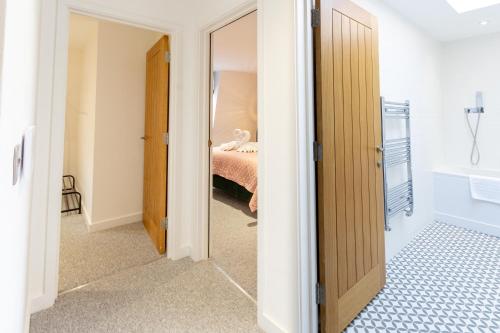 a room with a bedroom with a bed and a mirror at Regent Grand Penthouse in Brighton & Hove
