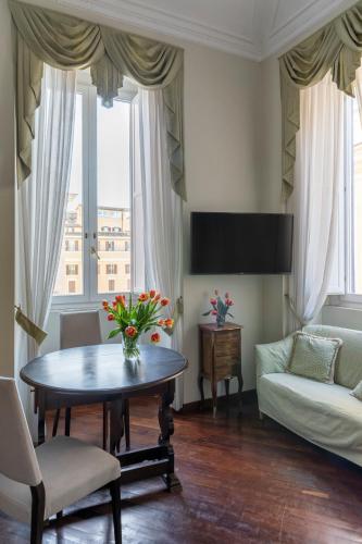 a living room with a table and a couch at Hotel Scalinata Di Spagna in Rome