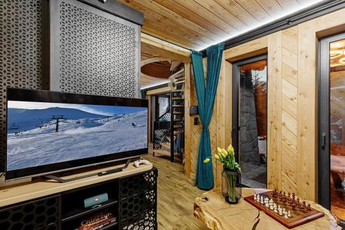 salon z telewizorem z płaskim ekranem w kabinie w obiekcie Chatka Kryjówka w mieście Kościelisko