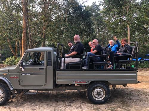 a group of people riding in the back of a truck at Hotel Happy Land in Chitwan