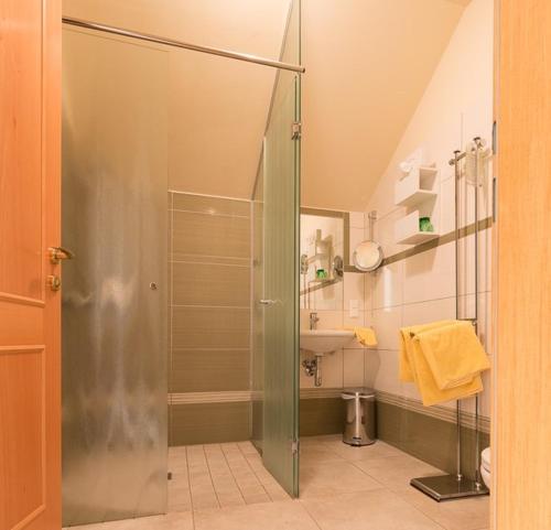 a shower with a glass door in a bathroom at Gasthof Pichler in Grimmenstein
