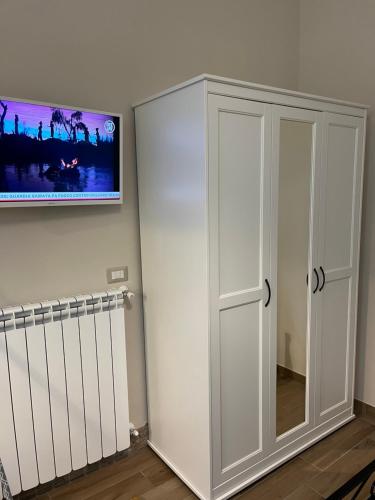 a white cabinet in a room with a tv on the wall at La Torre in Santo Padre