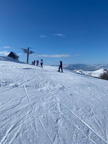 a group of people skiing down a snow covered slope at Stairway - Vučje in Nikšić